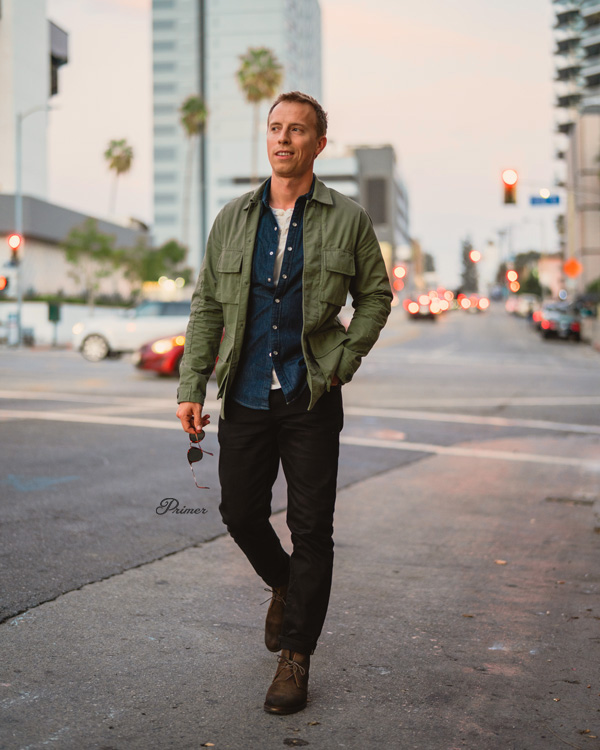 black jeans, blue button up shirt, brown boots and olive green jacket