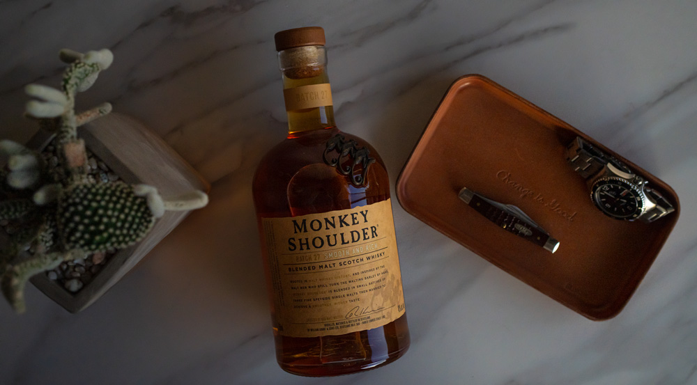 monkey shoulder blended malt scotch whisky bottle next to valet tray