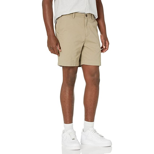 a man wearing slim fit shorts and tennis shoes