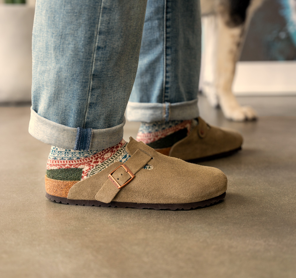 close up of birkenstock boston taupe suede worn with socks and jeans