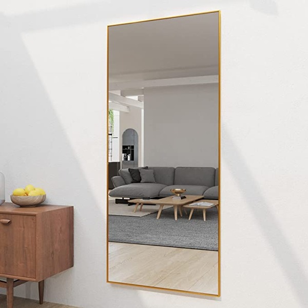 a full length mirror in a living room space