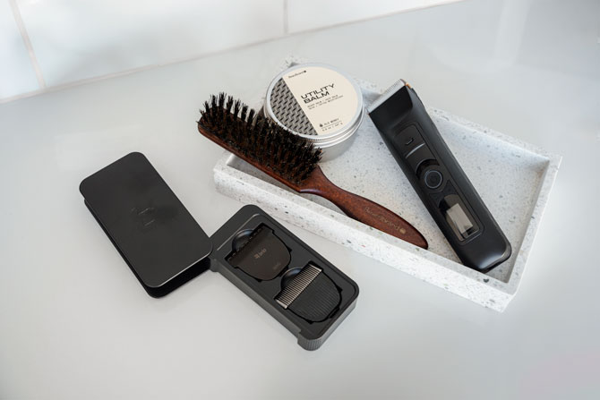 boars head beard brush, beard trimmer, and utility balm on a countertop