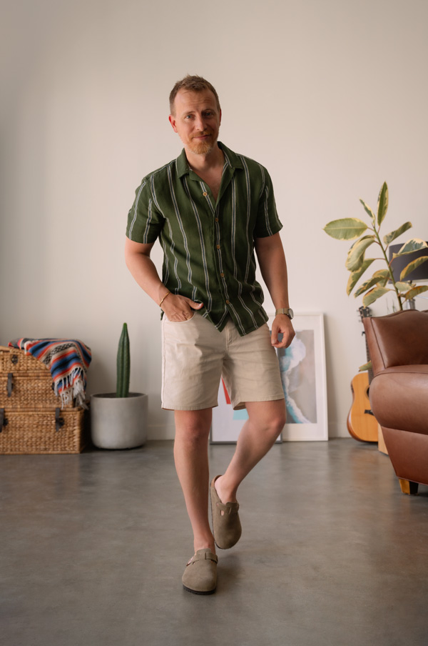 summer outfit with green striped shirt, beige shorts, and taupe birkenstock boston mules