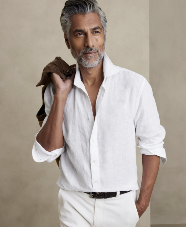 a man wearing a linen shirt with the sleeves rolled up