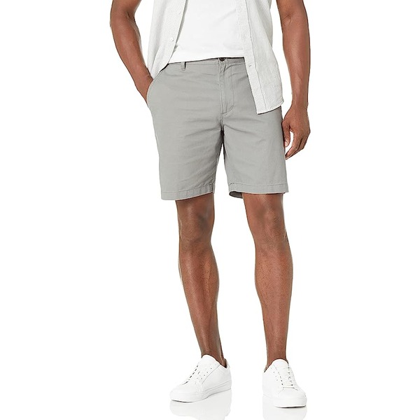 a man wearing classic fit shorts with low top sneakers