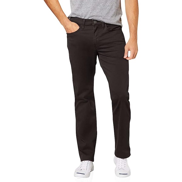 a man wearing straight fit pants with low top shoes