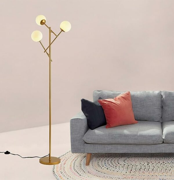 a floor lamp next to a sofa