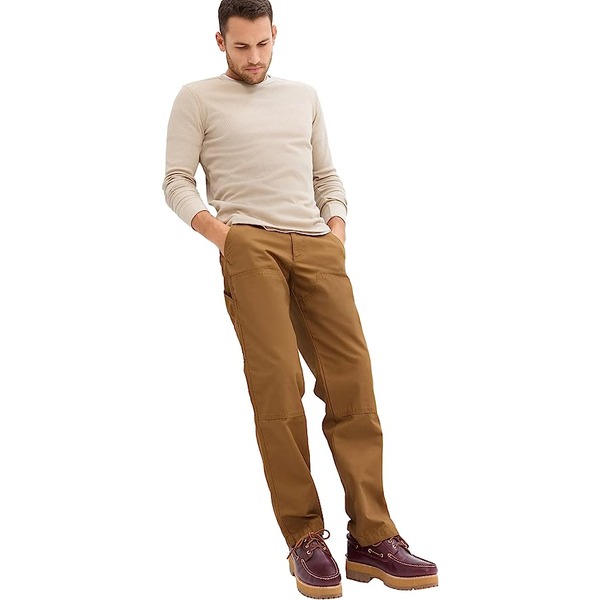 a man wearing cargo pants with a sweater and boots