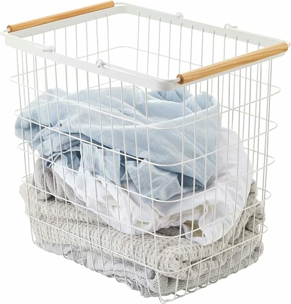 a wire laundry basket with wooden handles