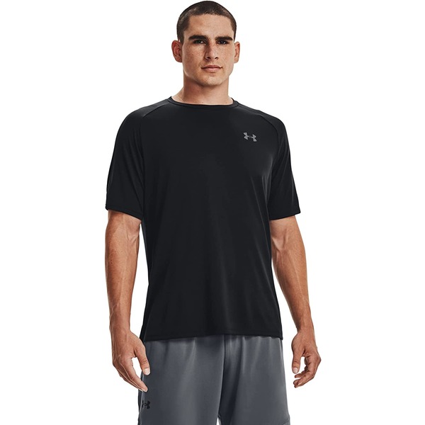 a man wearing a short sleeve shirt and gym shorts