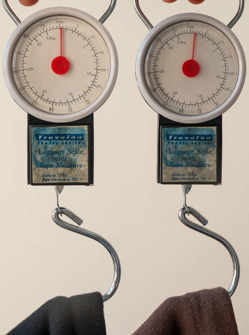 two scales showing the weights of two hoodies, with the one on the left barely registering weight and the Flint & Tinder one on the right weighing almost 2 lbs. 