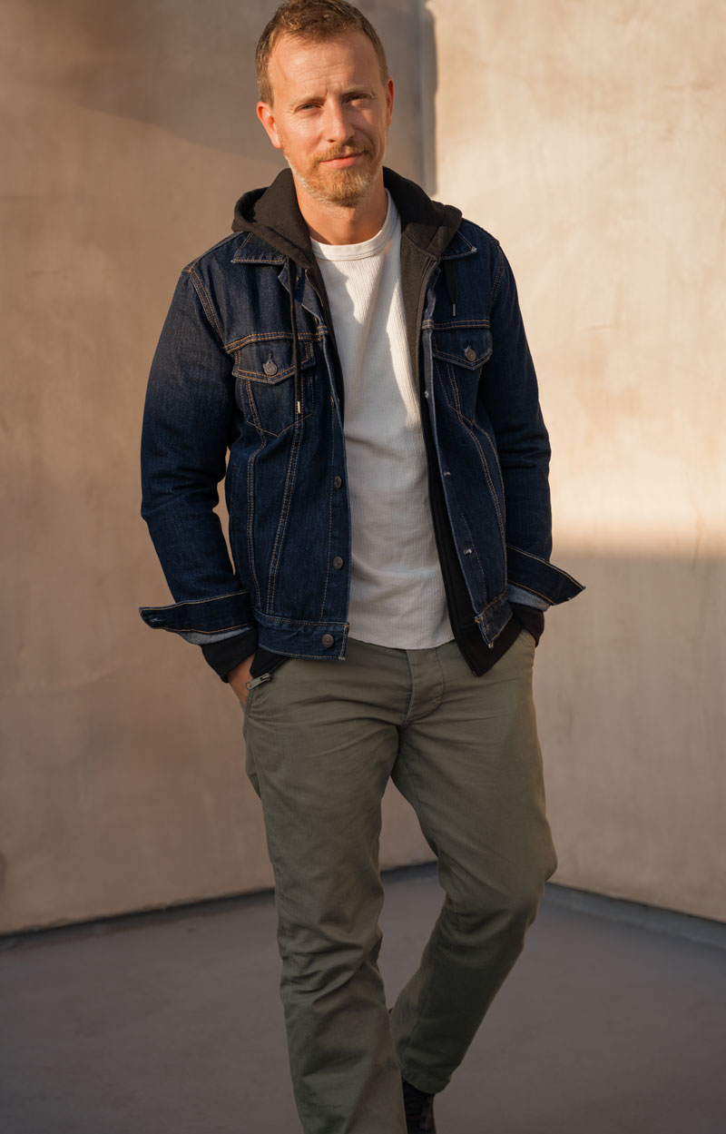 fall casual outfit with a denim jacket, black hoodie, and thermal