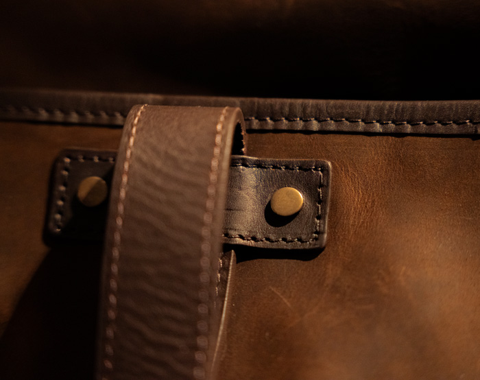 close up of brass hardware on reinforced leather handles