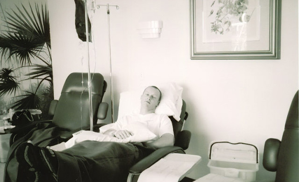 man laying on a hospital bed in recovery
