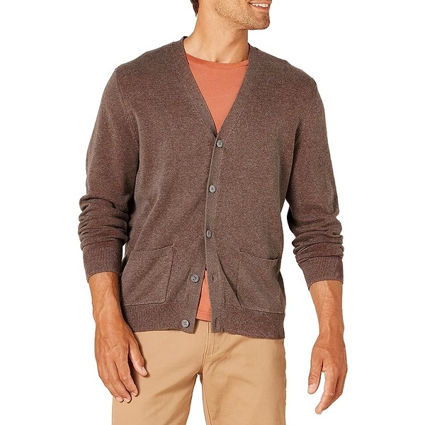 a man wearing a cardigan sweater over a shirt and pants