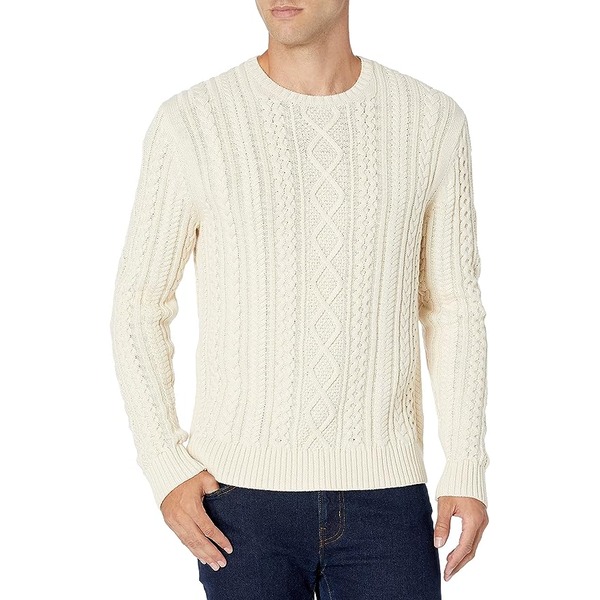 a man wearing a cable knit fisherman style sweater