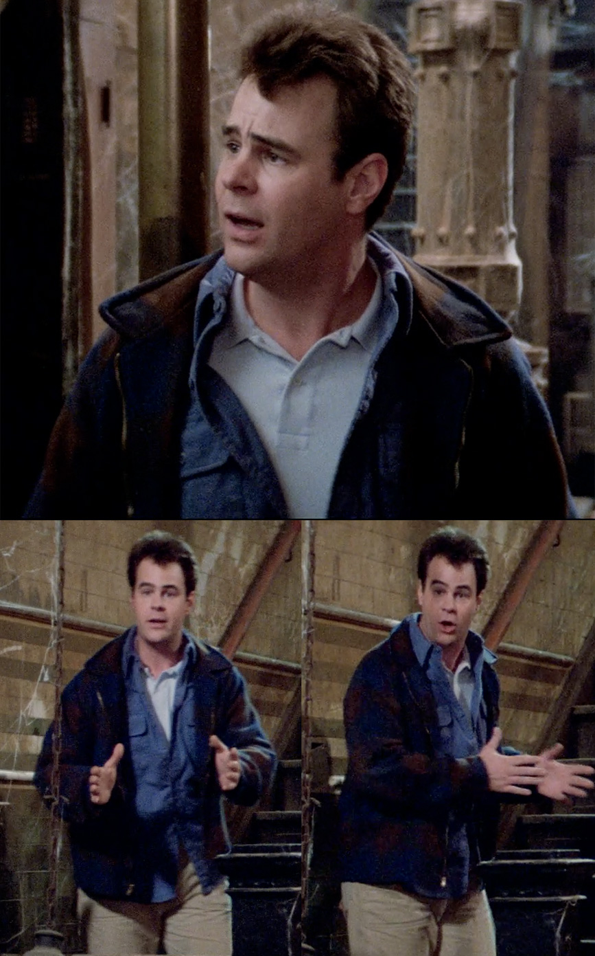 Film stills from the 1984 'Ghostbusters' showing Ray Stantz in a dark blue plaid jacket layered over a light blue shirt, paired with beige utility pants. He appears surprised in an old building with wooden and brick backgrounds.