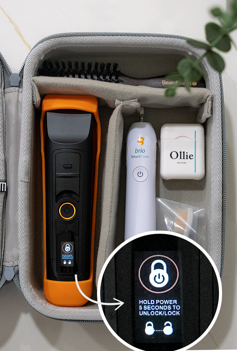 a hard sided travel toiletries case with a beard trimmer displaying a travel lock setting, an electric toothbrush, ollie floss, and a beard brush