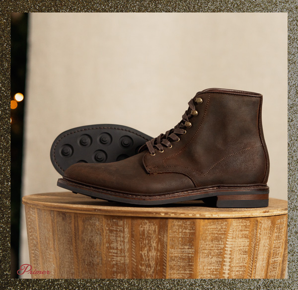 a men's brown leather boot on a pedestal
