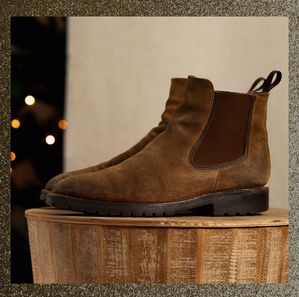 a pair of brown roughout suede chelsea boots with chunky soles