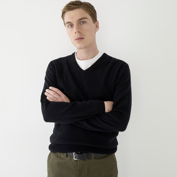 man wearing a v-neck cashmere sweater over pants
