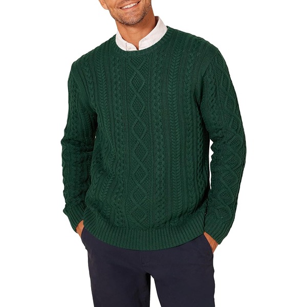 man wearing a fisherman cable crewneck sweater over pants