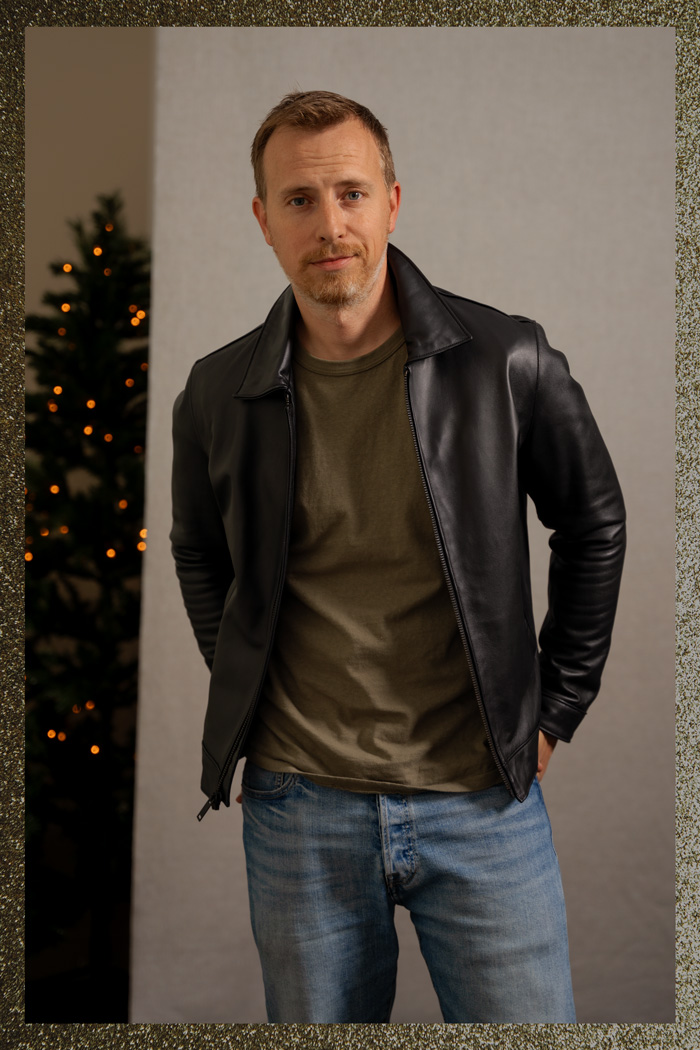 man wearing black leather jacket with green t-shirt