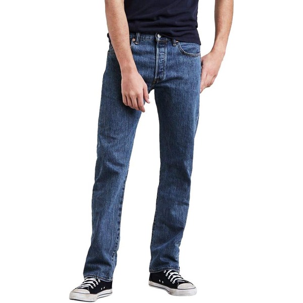 man wearing denim jeans with a shirt and casual sneakers