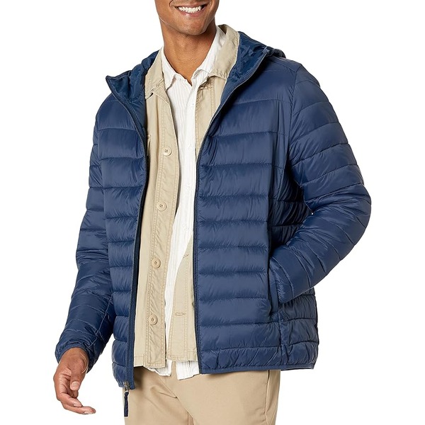 man wearing a hooded puffer jacket over a button down shirt and pants