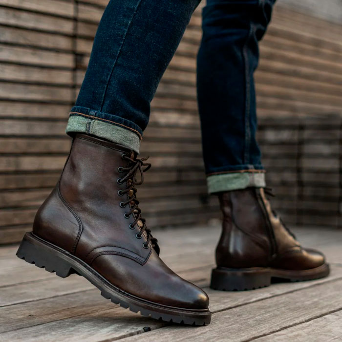 man wearing dark brown leather boots with thick sole