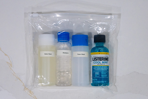 4 travel sized toiletry bottles in a plastic zip bag