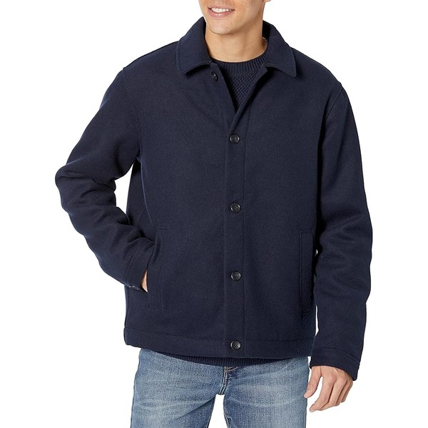 man wearing a short wool jacket over denim jeans