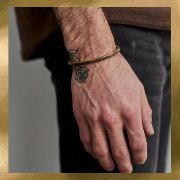 man wearing brass bracelet cuff