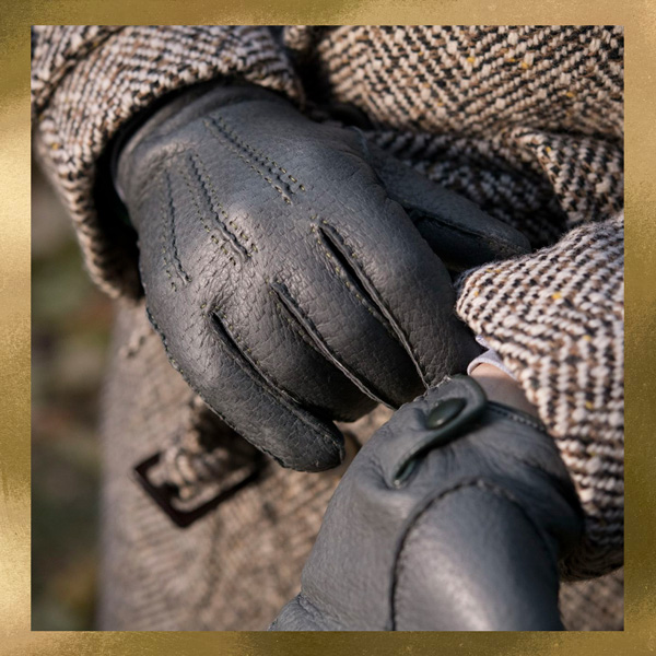 man wearing black leather gloves