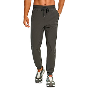 a man wearing athletic jogger drawstring waist pant and athletic shoes