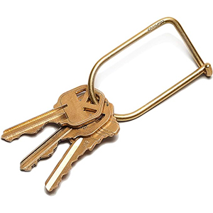 a brass key ring with a set of three keys 