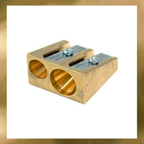 a brass pencil sharpener with two holes and removable blades