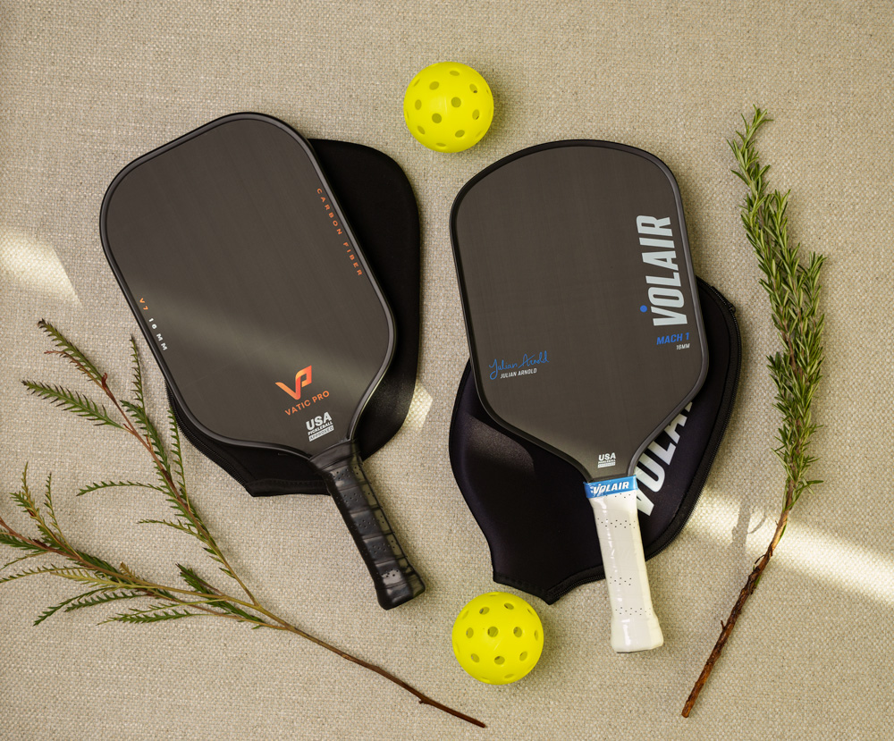 two pickleball paddles and balls