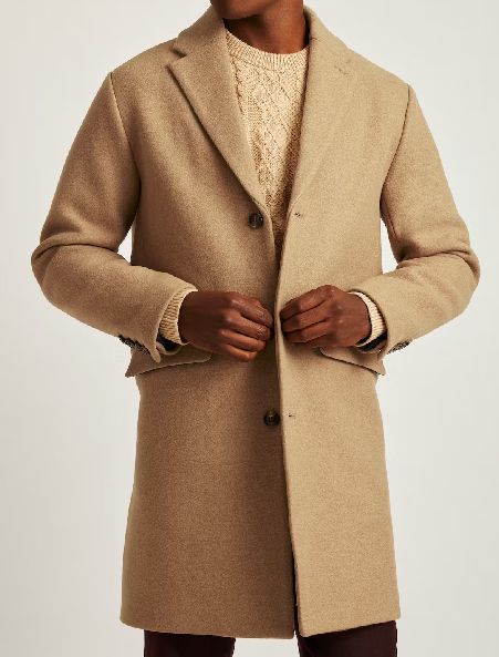 a man wearing a wool topcoat over a sweater