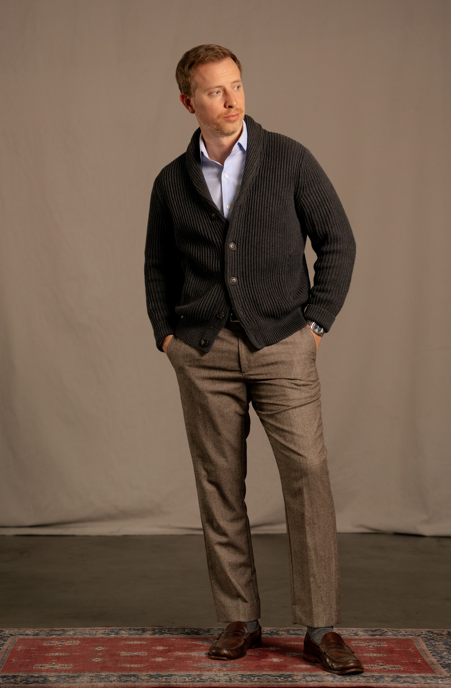 A business casual outfit with a gray shawl collar cardigan instead of a blazer, with a dress shirt and brown dress pants
