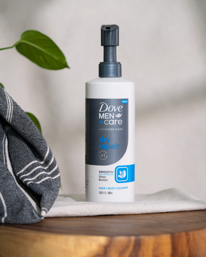 A pump bottle of Dove Men+Care Dry Repair face and body cleanser