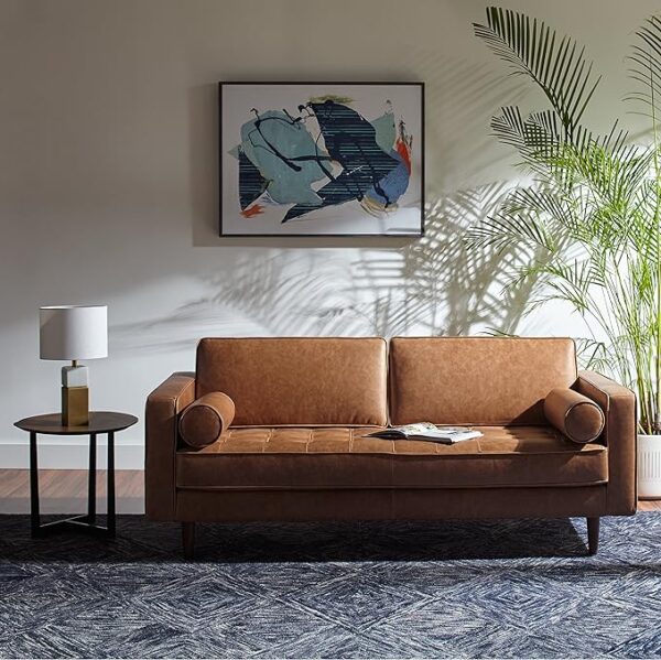 a leather loveseat couch in a living room space