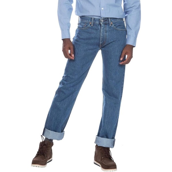 a man wearing regular fit levis jeans with boots and a long sleeve shirt