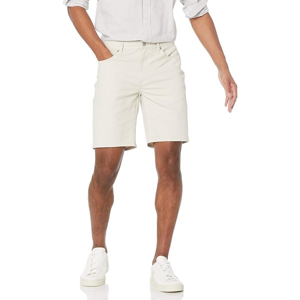 a man wearing a 9 inch inseam stretch shorts with casual sneakers 