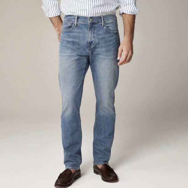 a man wearing straight fit denim jeans with loafer shoes