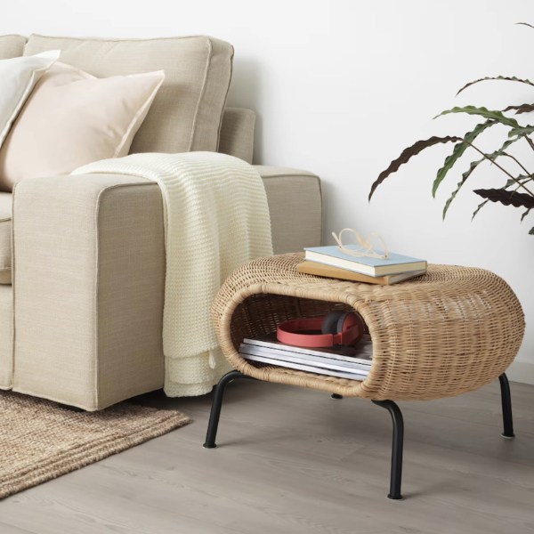 a rattan material ottoman with storage featured as a side table beside a couch