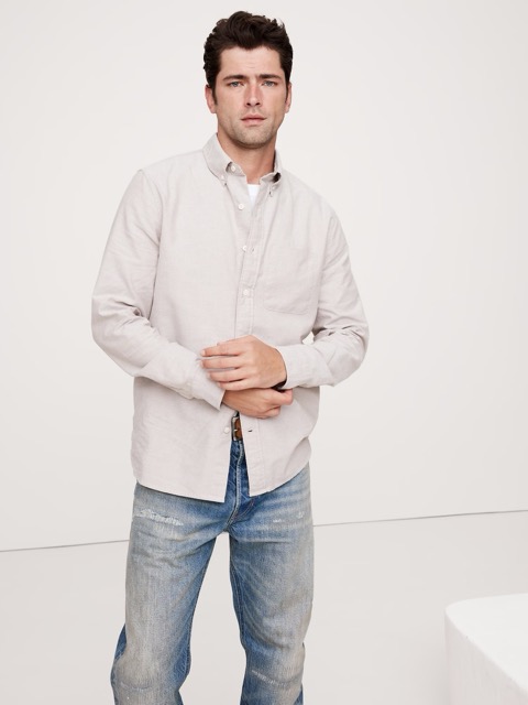 Man wears a gray dress button