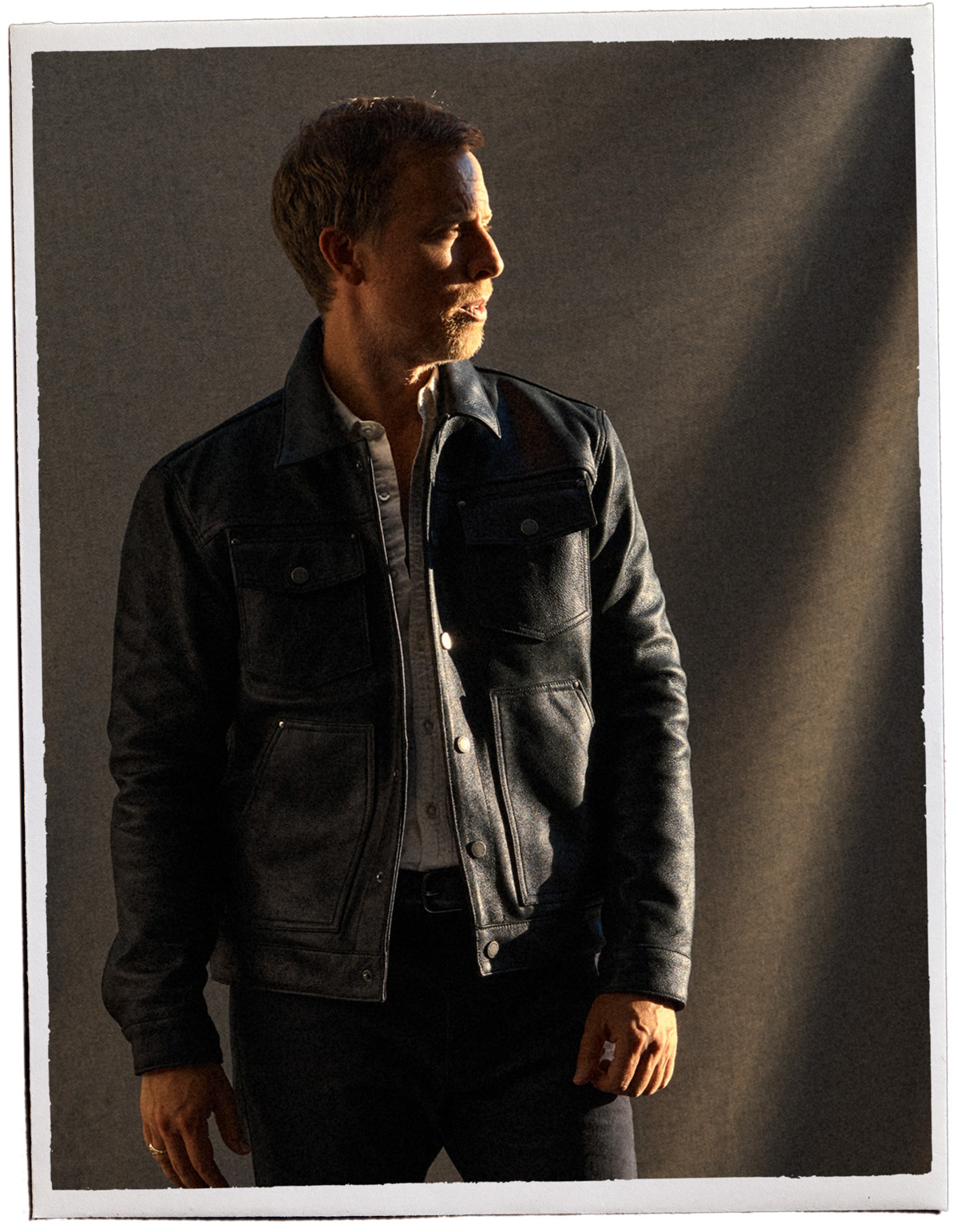men's all black fall outfit with black leather jacket, white button up shirt, black belts and black pants