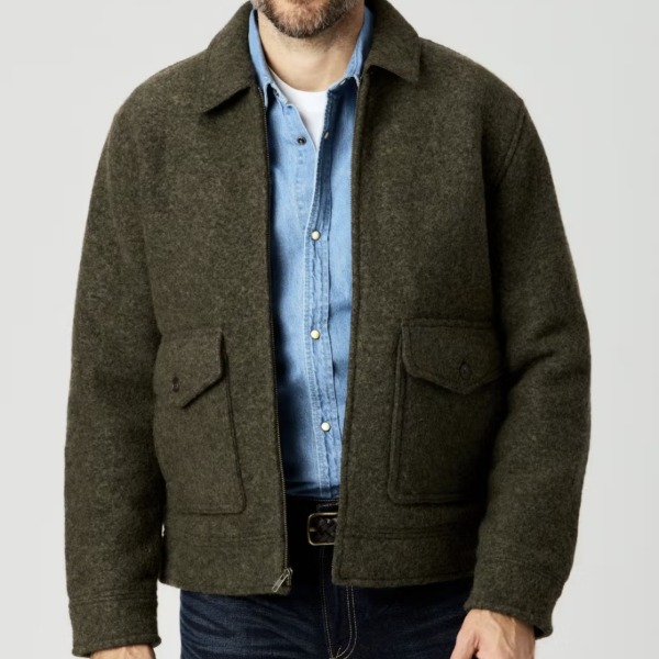 man wearing a boiled wool jacket over a button up shirt and pants