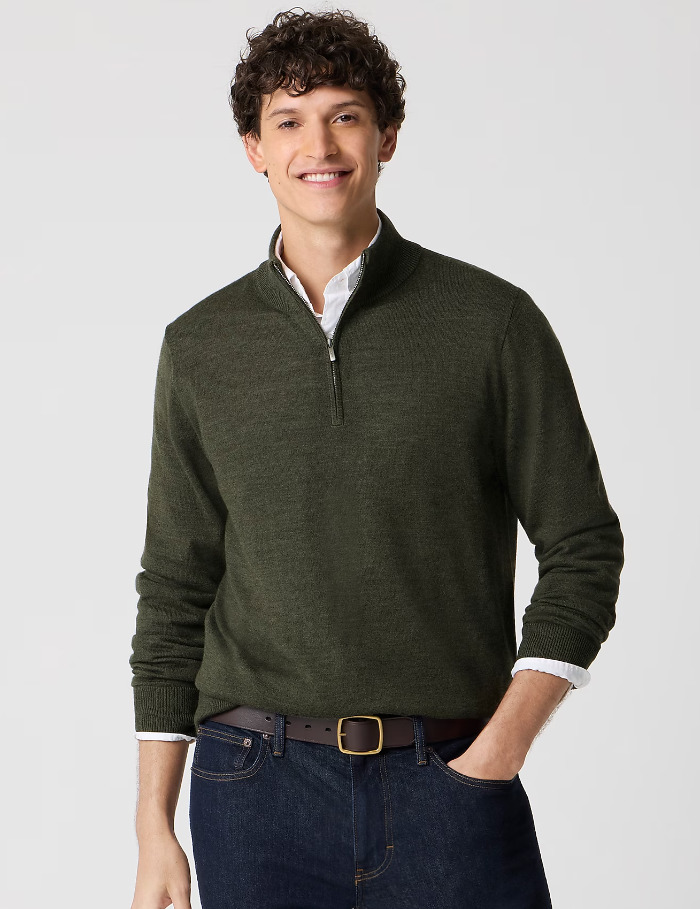 a man wearing a green merino wool blend quarter zip sweater